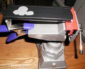 Mounted the cover on a small vise with the other end being held with a 